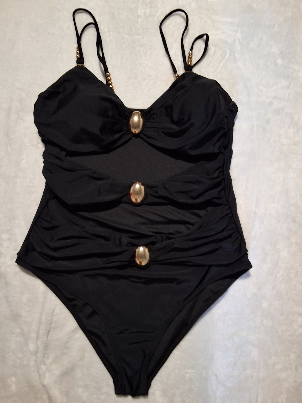 vintage-style black ruched cutout one-piece swimsuit detailed with central meta